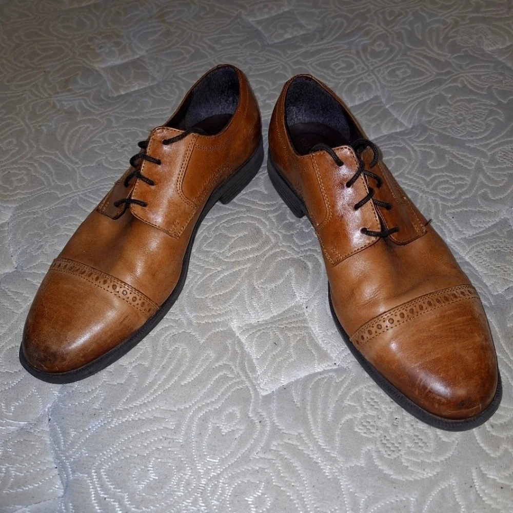A pair of Cole Haan Oxfords in a men's size 12M. Pre-loved in good condition.